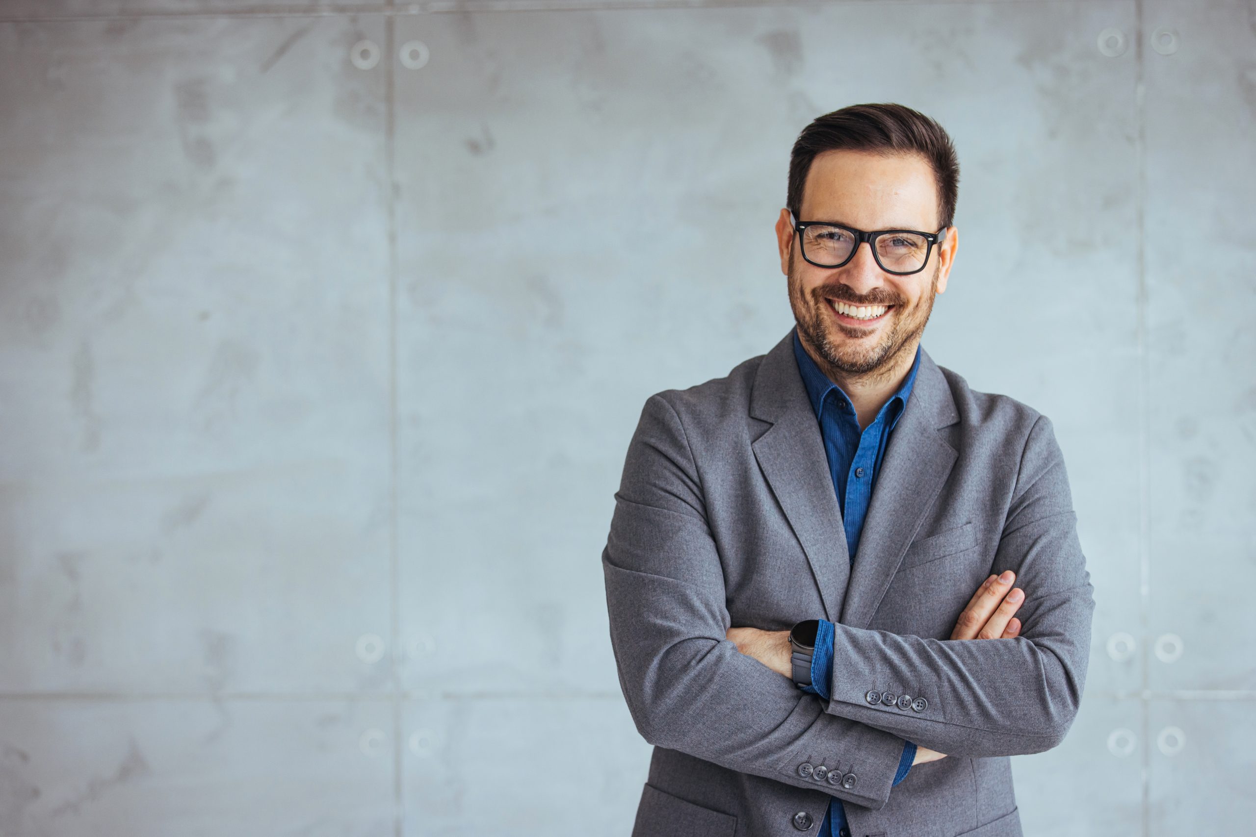 Businessman,Smiling,With,Arms,Crossed,On,White,Background.,Portrait,Of